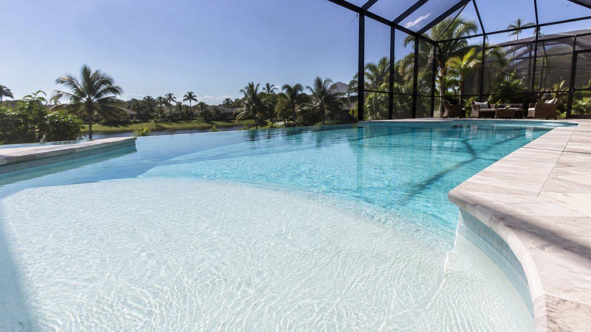 Close view of a smooth white plaster pool finish under clear water