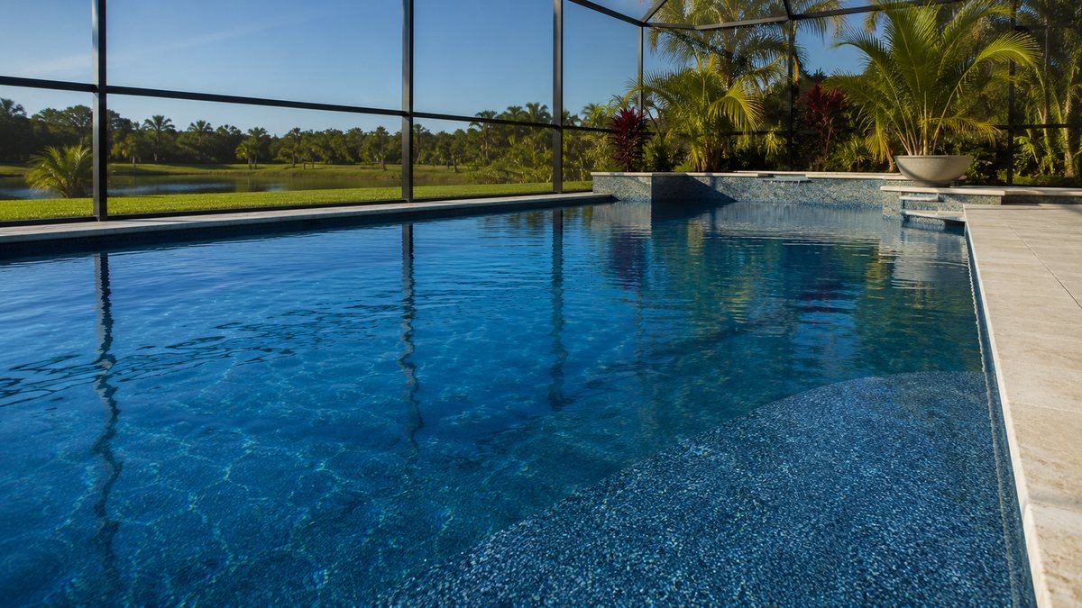 A residential pool with a quartz finish showing a rich blue tone and subtle sparkle
