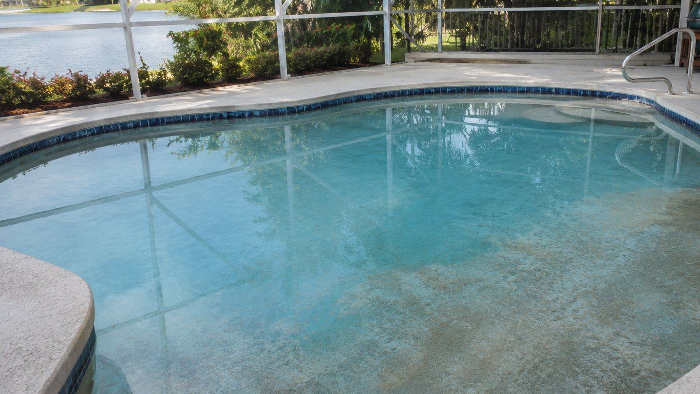 A well-maintained residential pool in a Cape Coral backyard